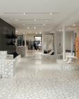 White marble terrazzo used for the floor and staircase of a clothing store in the United States
