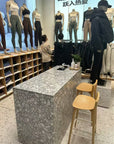The island counter with white marble terrazzo on gray background in the clothing store
