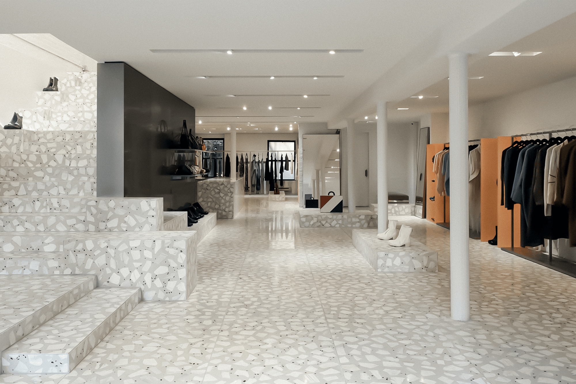 White marble terrazzo used for the floor and staircase of a clothing store in the United States