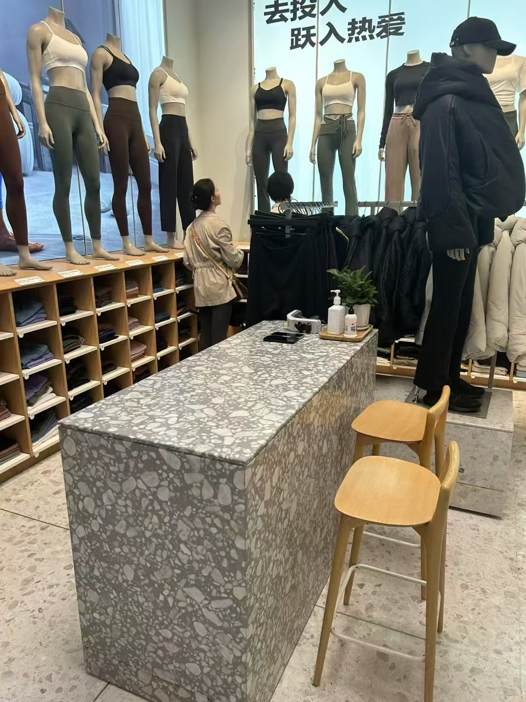 The island counter with white marble terrazzo on gray background in the clothing store